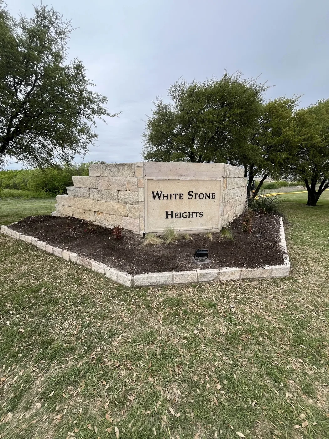 Entrance Sign before landscaping transformation by JP Landscapes in Dallas-Fort Worth